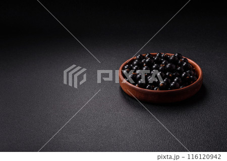 Ripe blackcurrant berries in droplets of water in a ceramic bowl Ripe blackcurrant berries in droplets of water in a ceramic bowl 116120942