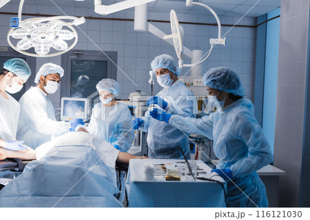 Team of anesthetists preparing patient for surgery at the operating room 116121030