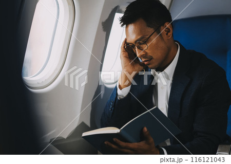 Business Man Having Headache Pain or Frustration Problem in Interior of an Airplane, Corporate Airline Travel Concept Business Man Having Headache Pain or Frustration Problem in Interior of an Airplane, Corporate Airline Travel Concept 116121043