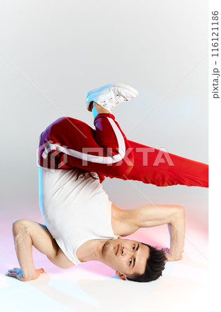 asian b-boy exercising in break dance on white background doing shoulder freeze 116121186