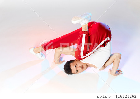 BBoy doing Chair Classic Freeze, working out over technique in white classroom 116121262