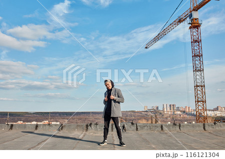 Asian hip-hop man break dancer posing outdoor on the roof 116121304