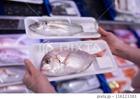 魚を選ぶ女性の手元 116121383