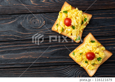 Healthy vegetarian breakfast . Scrambled eggs toast with cherry tomatoes and parsley 116121879