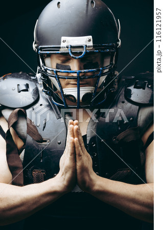 American football player with ball wearing helmet and protective shields American football player with ball wearing helmet and protective shields 116121957