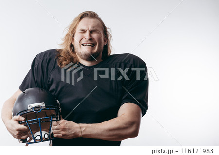 Rugby football player in despair, man with long hair over isolated background 116121983