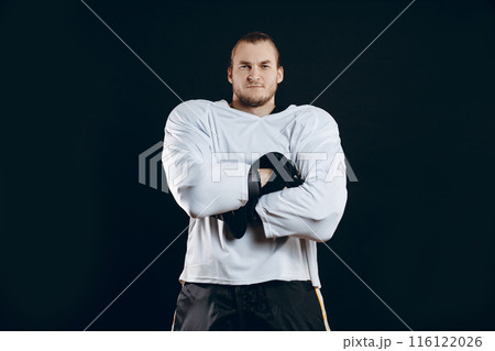 Portrait of ice-hockey player with hockey stick 116122026