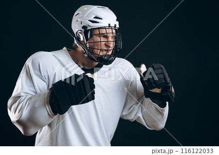 Portrait of ice-hockey player with hockey stick and protective gloves 116122033