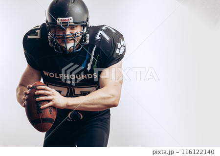 Quarterback throwing a football in a professional football game Quarterback throwing a football in a professional football game 116122140