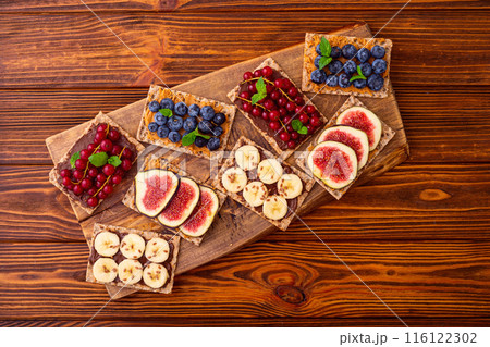 Protein toast crispbread with delicious toppings top view Protein toast crispbread with delicious toppings top view 116122302