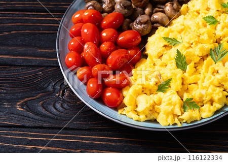 Homemade scrambled eggs with mushrooms and cherry tomatoes 116122334