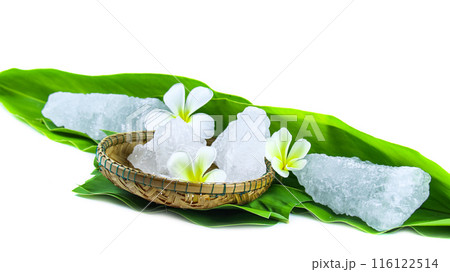 White crystal clear alum cube on green leaf isolated on white background. White crystal clear alum cube on green leaf isolated on white background. 116122514