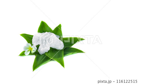 White crystal clear alum cube on green leaf isolated on white background. White crystal clear alum cube on green leaf isolated on white background. 116122515