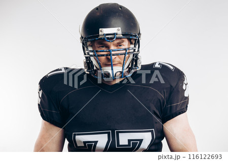 American football player with helmet and armour against white background American football player with helmet and armour against white background 116122693