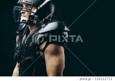 American football player with ball wearing helmet and protective shields American football player with ball wearing helmet and protective shields 116122711