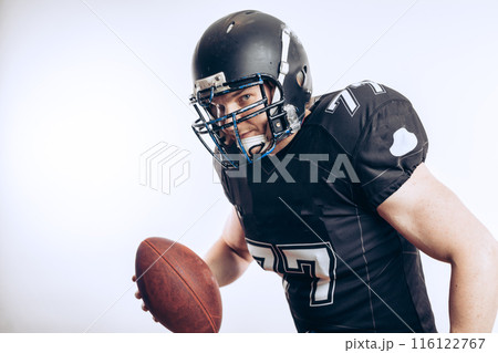 Quarterback throwing a football in a professional football game 116122767