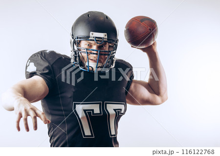 Quarterback throwing a football in a professional football game Quarterback throwing a football in a professional football game 116122768