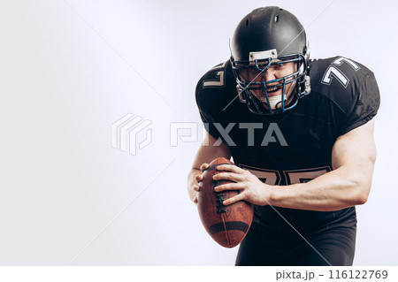 Quarterback throwing a football in a professional football game Quarterback throwing a football in a professional football game 116122769