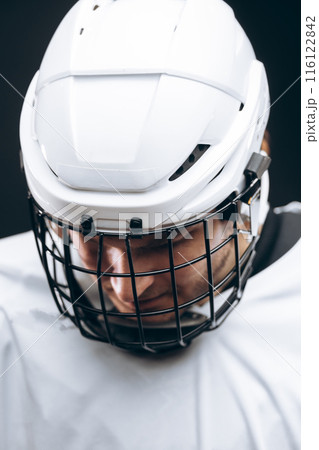 Portrait of sportsman in hockey uniform over black background 116122842