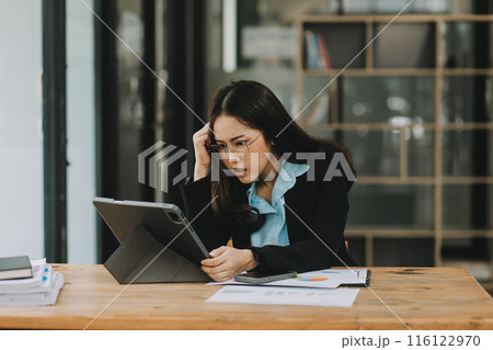 Asian women are stressed while working on laptop, Tired asian businesswoman with headache at office, feeling sick at work, copy space Asian women are stressed while working on laptop, Tired asian businesswoman with headache at office, feeling sick at work, copy space 116122970