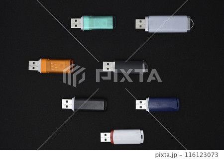 USB flash drives on a black background. The information carrier. Several flash drives. 116123073