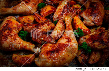 Roast chicken legs with potatoes and onions in the oven, homemade. No people. 116123144