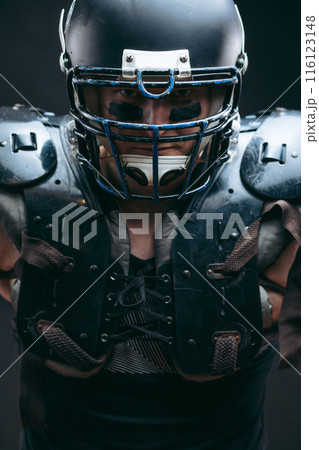 Portrait of american football player in protective shields on naked torso 116123148