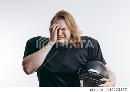 Rugby football player in despair, man with long hair over isolated background Rugby football player in despair, man with long hair over isolated background 116123177