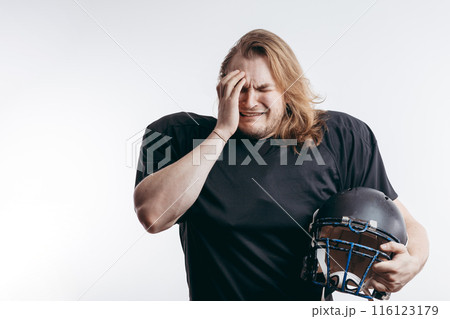 Rugby football player in despair, man with long hair over isolated background Rugby football player in despair, man with long hair over isolated background 116123179