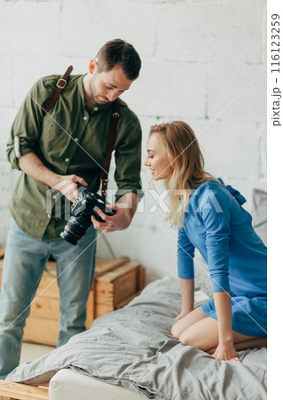 sweet lovely girl controlling the work of a photographer 116123259