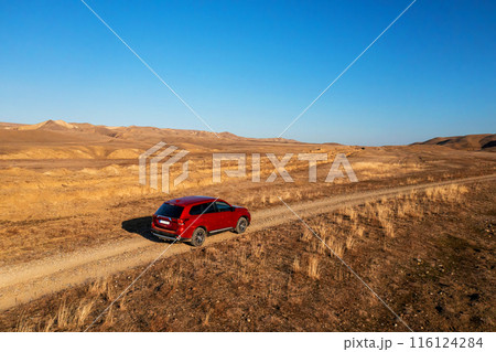 Red SUV on a Dusty Rural Road in Georgia Countryside During Daytime 116124284