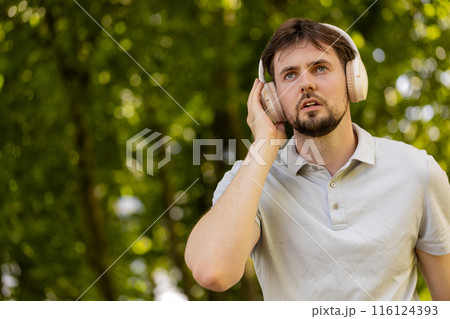 From below of athletic fitness sport runner man training marathon run, listening music in headphones From below of athletic fitness sport runner man training marathon run, listening music in headphones 116124393