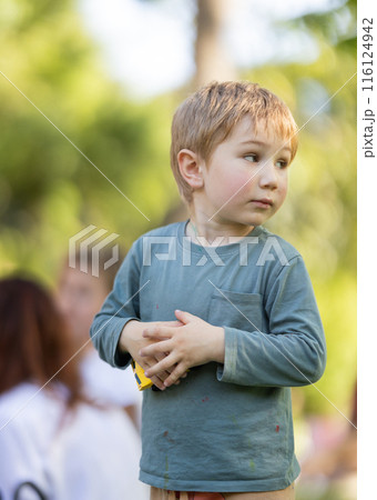 A young boy wearing a green shirt A young boy wearing a green shirt 116124942