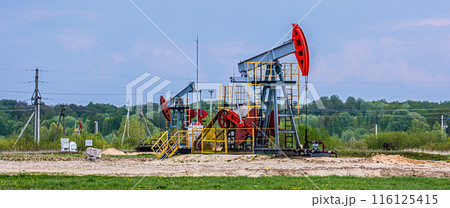 Oil drilling derrick pumps oil from ground. Petroleum industry, crude oil extraction. Production of fuel from natural resources. Oil crisis. Banner format. Oil drilling derrick pumps oil from ground. Petroleum industry, crude oil extraction. Production of fuel from natural resources. Oil crisis. Banner format. 116125415