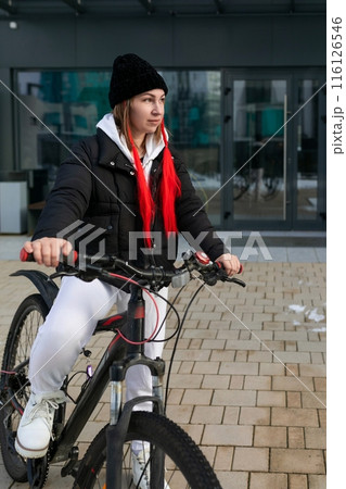 A woman went for a walk and took her bicycle with her in winter A woman went for a walk and took her bicycle with her in winter 116126546