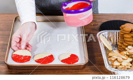 Crafting star-shaped holiday cookies dipped in chocolate and sprinkled with variety of toppings. Crafting star-shaped holiday cookies dipped in chocolate and sprinkled with variety of toppings. 116128679