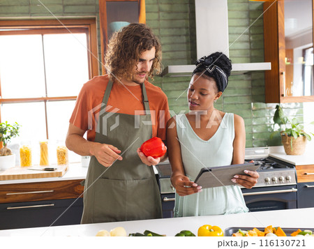 A diverse couple is cooking together in modern kitchen 116130721