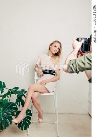 cheerful happy girl sitting on the chair and posing to the camera cheerful happy girl sitting on the chair and posing to the camera 116131806