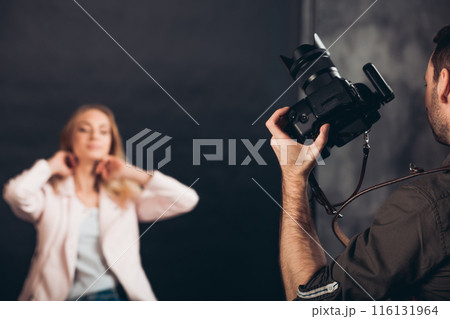attractive fair-haired girl doing hairstyle before the photo session attractive fair-haired girl doing hairstyle before the photo session 116131964