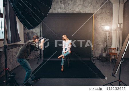 pleasant charming girl sitting with crossed legs 116132625