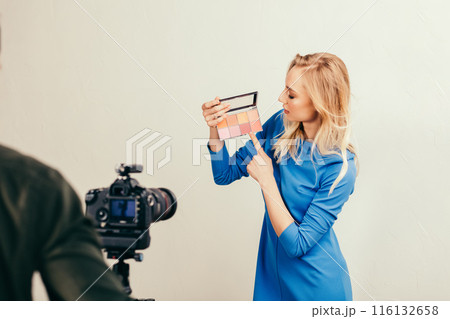 attractive charming girl pointing at ruddy, rosy attractive charming girl pointing at ruddy, rosy 116132658
