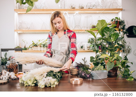 young good-looking florist woman in shop 116132800