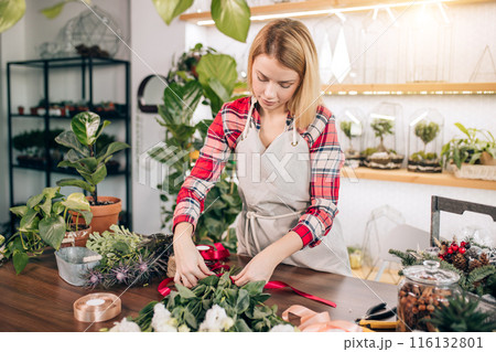 pretty young blond female making fashion modern bouquet of different flowers 116132801