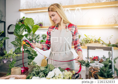 florist woman preparing bouquet of flowers florist woman preparing bouquet of flowers 116132833