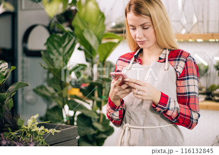 happy caucasian lady florist at work happy caucasian lady florist at work 116132845