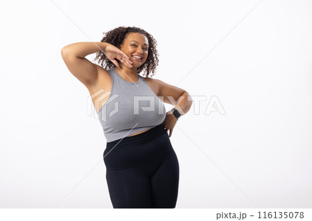 Biracial young female plus size model posing confidently on white background, hand on hip and behind Biracial young female plus size model posing confidently on white background, hand on hip and behind 116135078