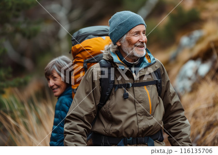 Senior Couple Hiking Through Autumn Woods 116135706