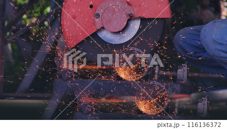 Hot flame welding metal work cutting fire iron workshop. Welding machine iron metal sparking. Locksmith using Welding machine cutting metal processing grinder. Close up hands Sparks in metalworking 116136372