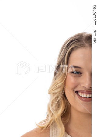 Plus-size Caucasian female with blonde hair smiles on white background, copy space 116136463