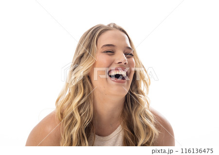 Young Caucasian female plus size model laughing, showing joy on white background, copy space 116136475